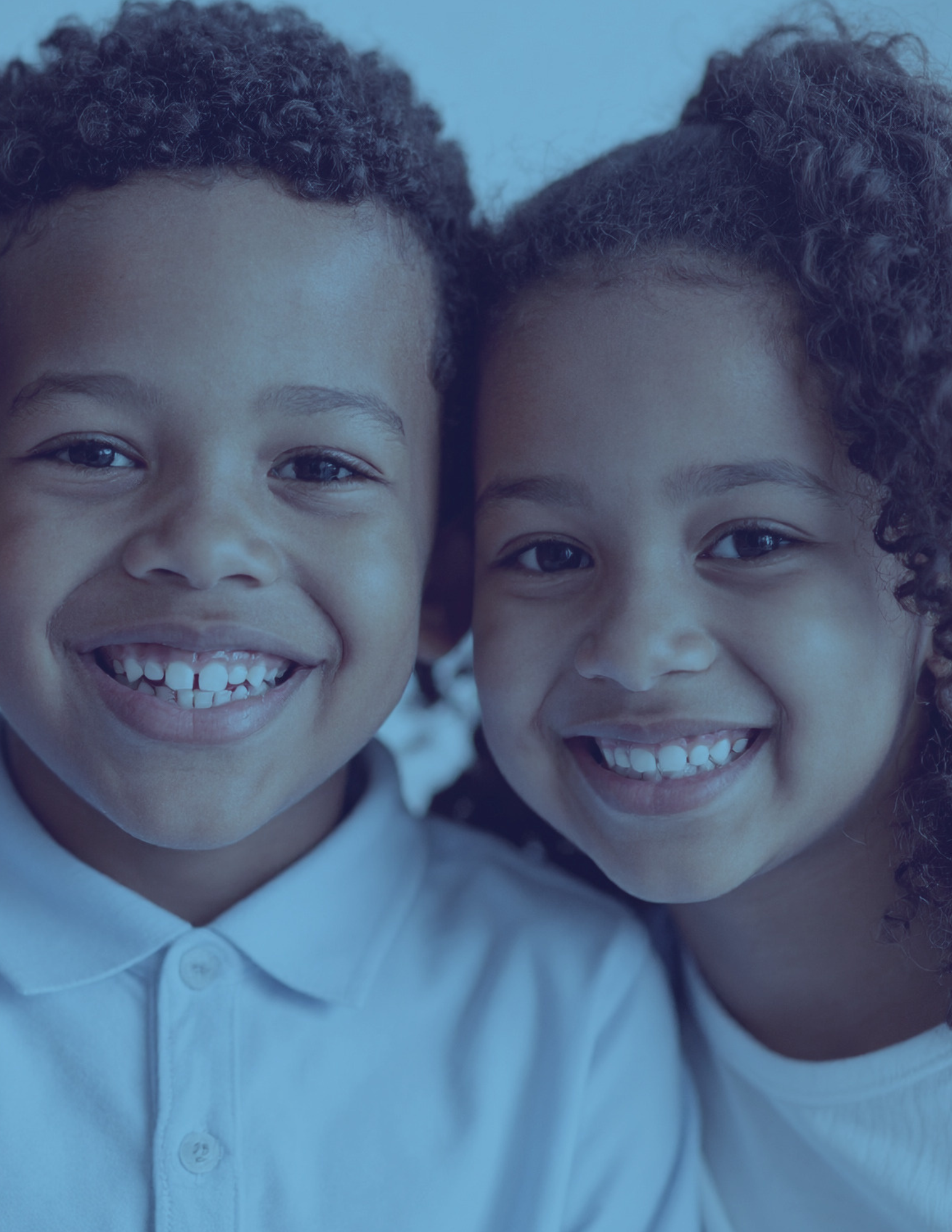 Two young children smiling